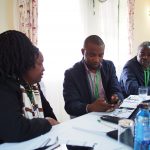 Dr Lusike Wasilwa, Director of Crop Systems, KALRO and Amos Tabalia, ACRE Africa, downloading the Telegram app and signing up to the PRISE pest forecasts.