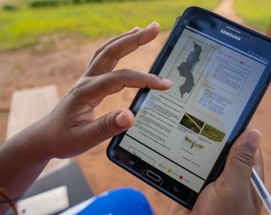 crop health advisor using a PRISE bulletin on their mobile tablet to access pest alert and advisory information